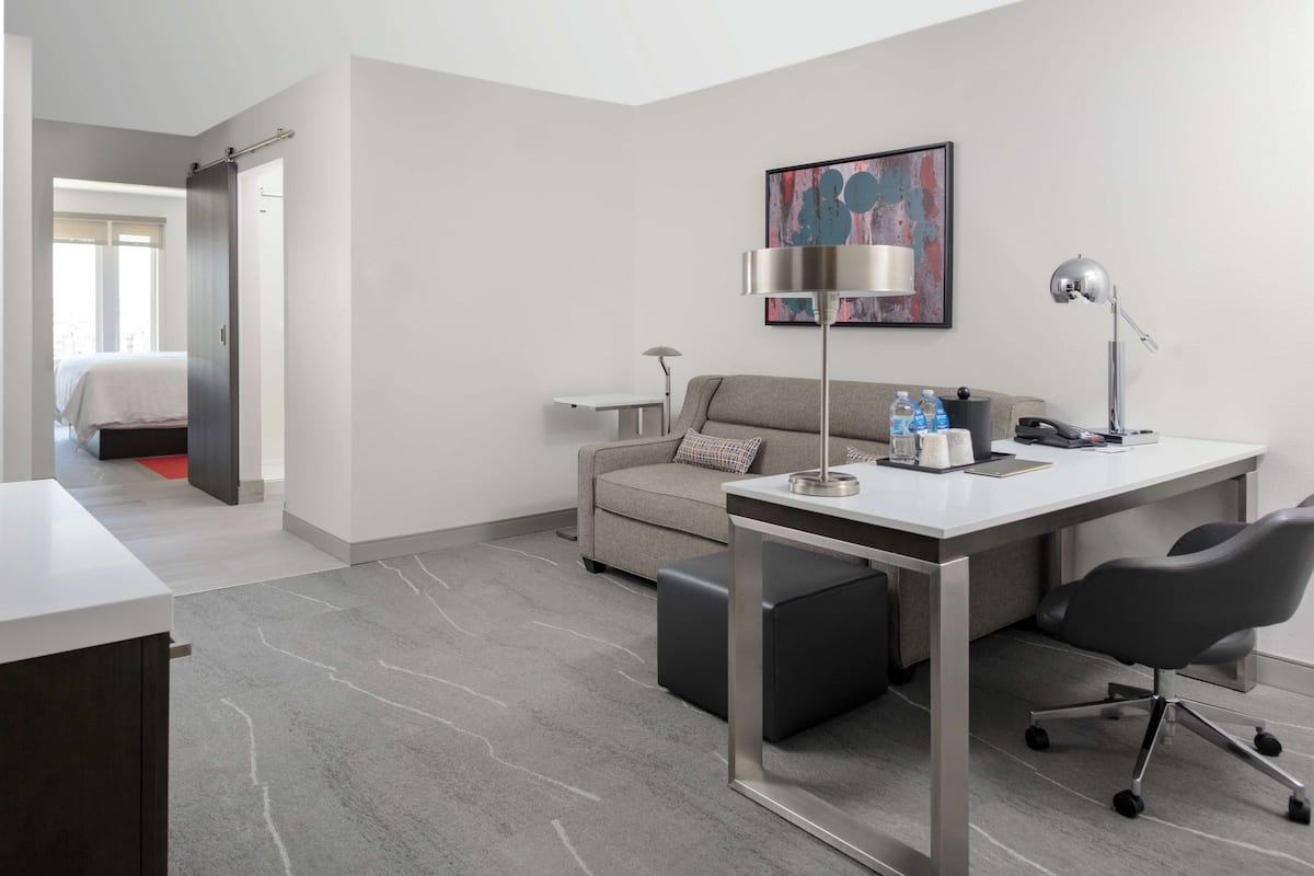 Premium bedding, desk, laptop workspace, blackout drapes