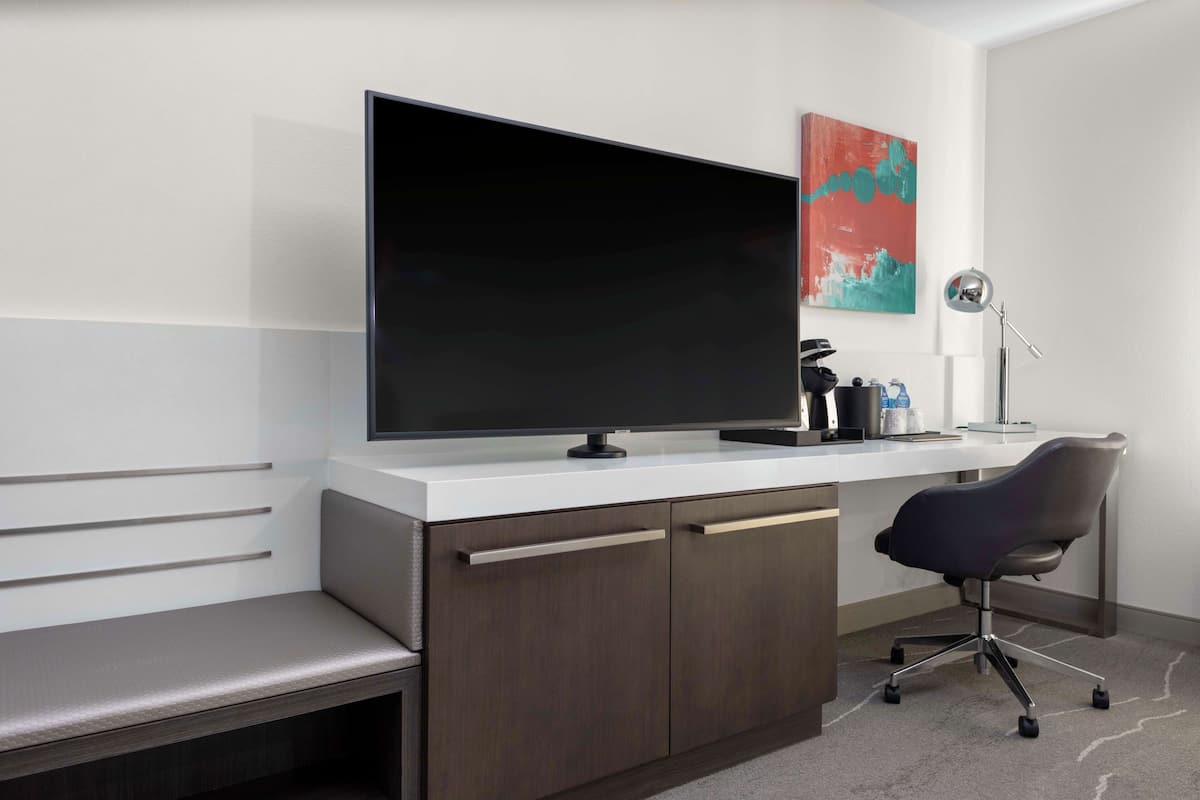 Premium bedding, desk, laptop workspace, blackout drapes