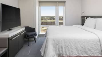 Premium bedding, desk, laptop workspace, blackout drapes