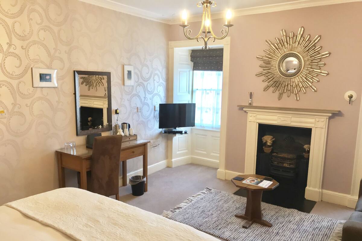 Desk, iron/ironing board, bed sheets