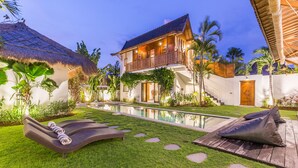 A luxurious villa with a swimming pool, outdoor seating, and a well-maintained garden. - Eco Chic 5BDR Oberoi/ Central Seminyak/beach (Seminyak)