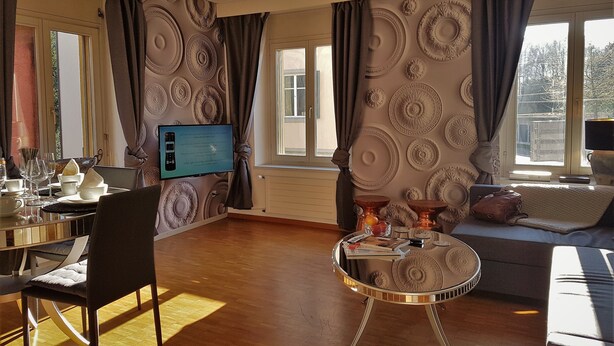 A well-lit living room with a dining area, a television, and a sofa. - New:Lovely 2.5 Room , Dish Washer, Wifi, Fully Equiped, own washer/dryer (Zürich)