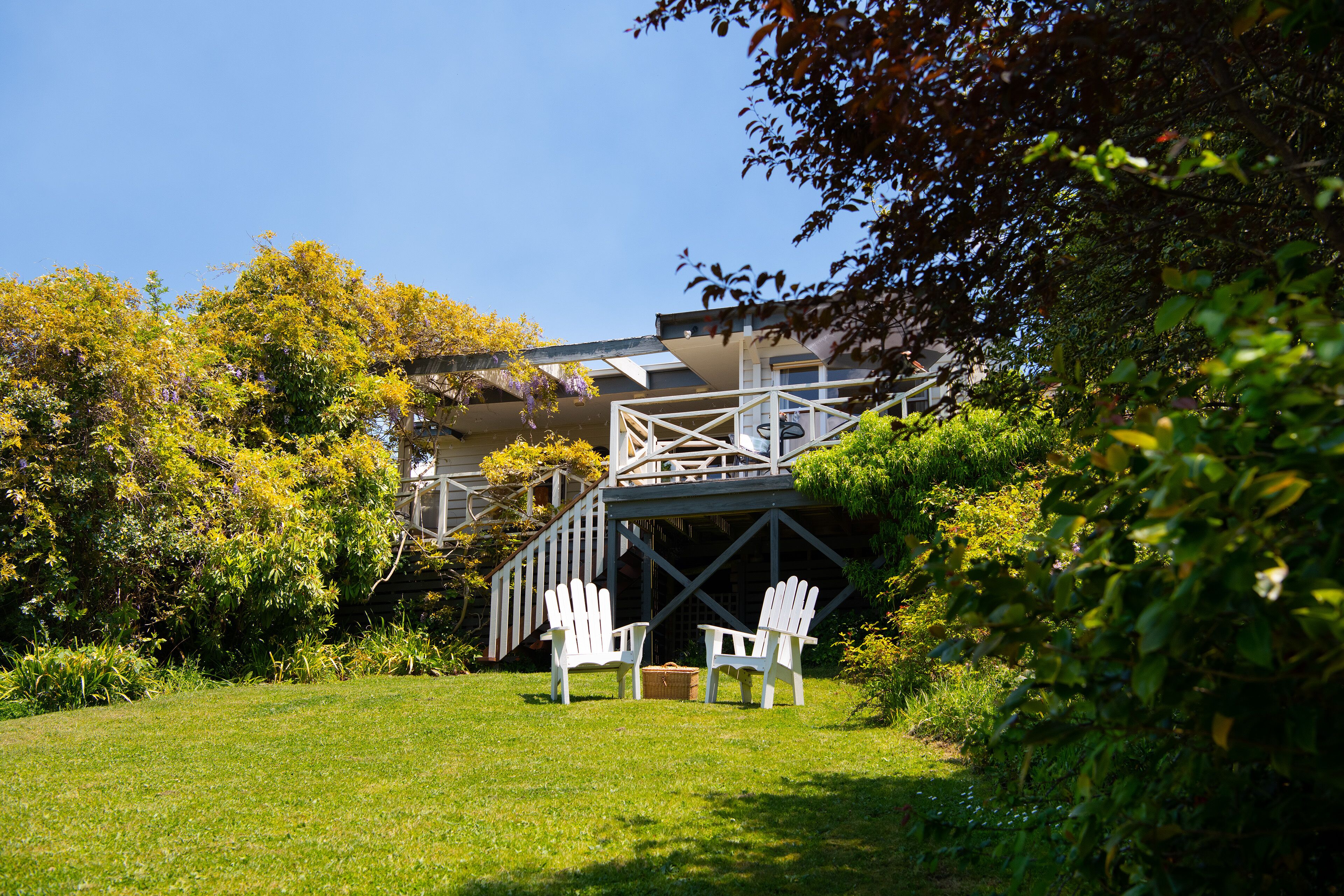 a large grassy lawn down to the lake