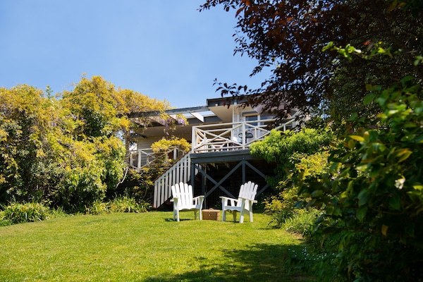 a large grassy lawn down to the lake