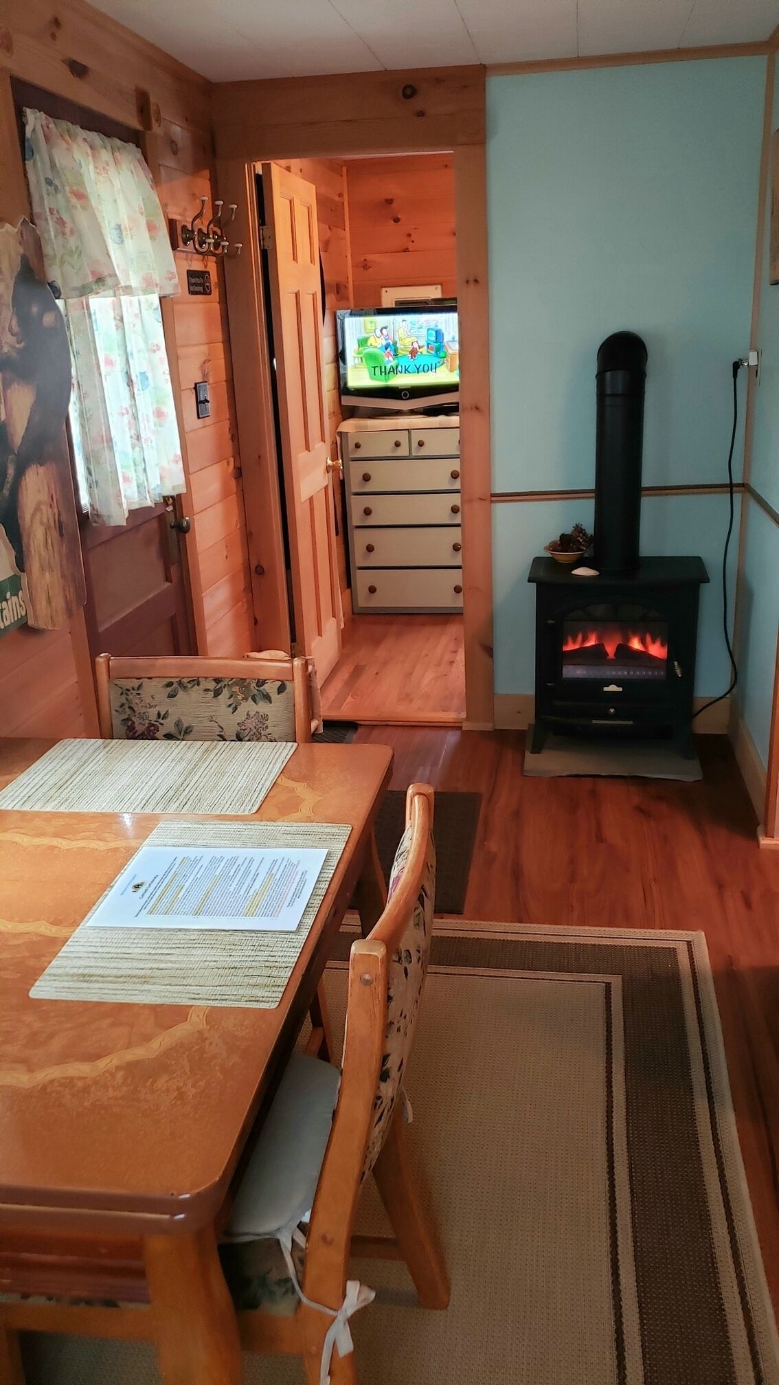 Dining/kitchen area, Electric Wood Stove, entry to bedroom