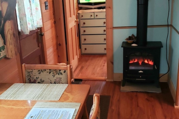 Dining/kitchen area, Electric Wood Stove, entry to bedroom