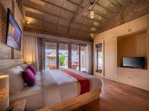 Cozy retreat with a large bed, TV, and wardrobe.
