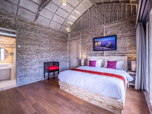 Relax in this cozy retreat with a large bed, TV, and comfortable seating area.
