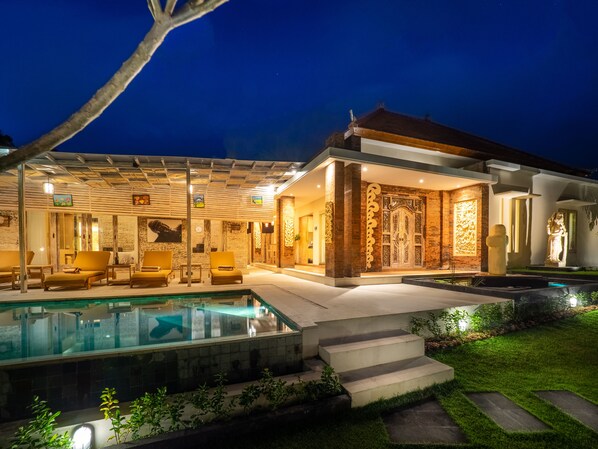 Enjoy a refreshing swim in the pool or relax in the covered outdoor seating area.
