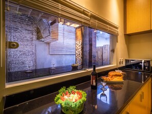 Enjoy cooking in this well-equipped kitchen with a large window and ample counter space.