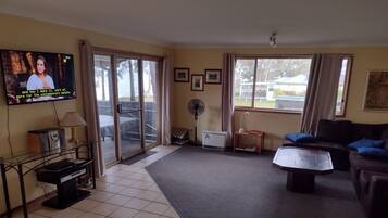 Flat-screen TV, DVD player, books, stereo