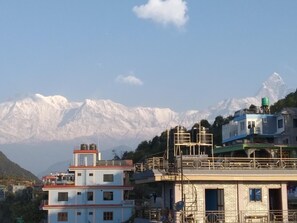 A building with a view of snow-capped mountains in the background.