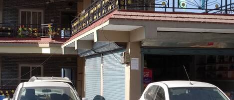 A building with a sign for "High Ground Inn & Roof Top Restaurant" and a closed shop with a Coca-Cola sign.