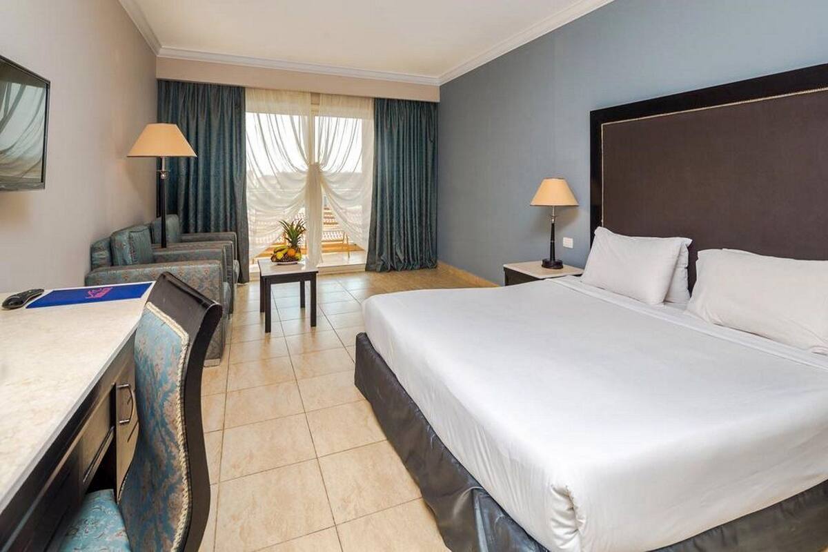Standard Double Room | Minibar, in-room safe, iron/ironing board (on request), bed sheets