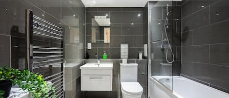 Combined shower/bathtub, hair dryer, towels, soap