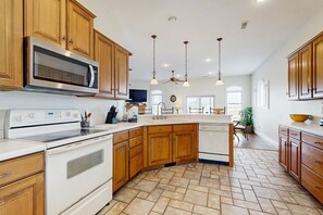 Enjoy cooking in this well-equipped kitchen with a central island, sink, and microwave and oven.