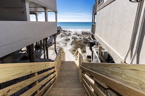 Stairs lead to a serene beach view.