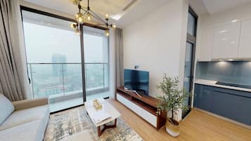 Apartamento superluxo, 2 quartos | Área de estar | TV de tela plana 49 polegadas com canais a cabo, TV