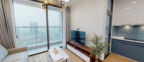 Apartamento de lujo, 2 habitaciones | Zona de estar | Televisión de pantalla plana de 49 pulgadas con canales por cable