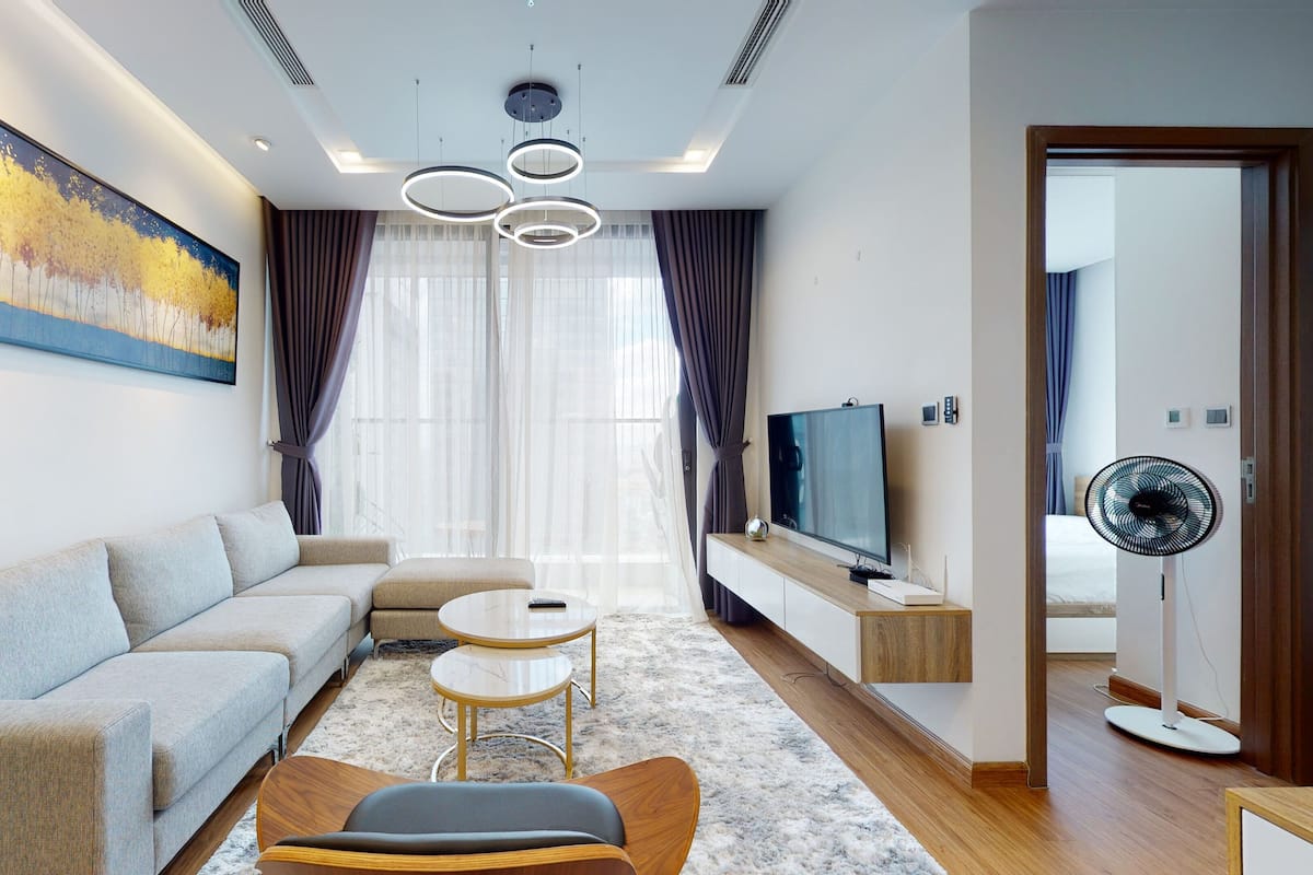A modern living room with a sofa, coffee table, and TV.