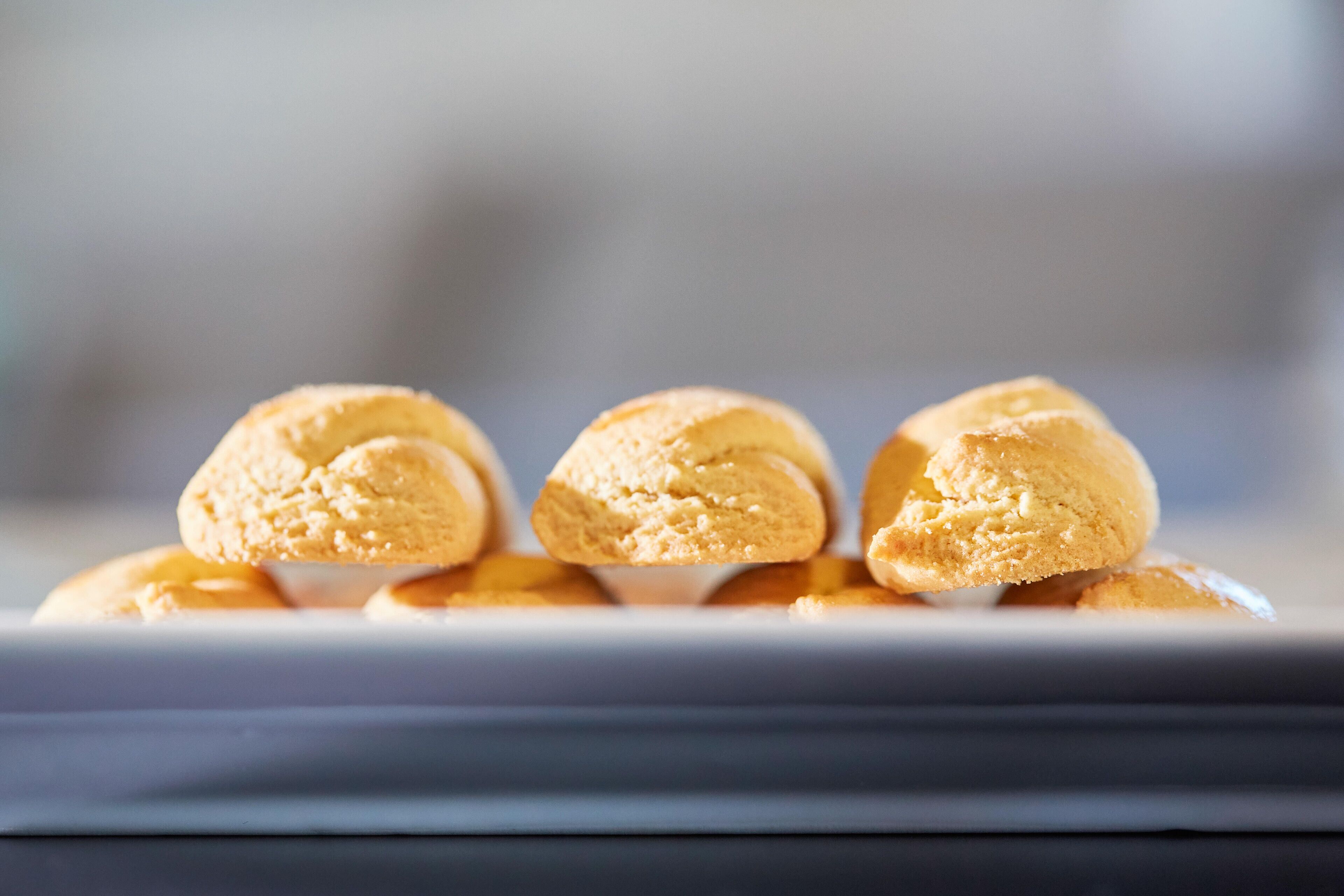 A tray of golden-brown pastries on a white plate.