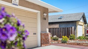 A residential property with a garage, a brick pillar, and a mailbox. - Spacious Open Floor Plan (Santa Cruz)