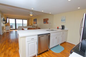 A spacious kitchen with a dishwasher, a sink, and a stove.