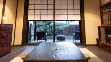 A traditional Japanese room with tatami flooring, a low wooden table, and sliding shoji doors.