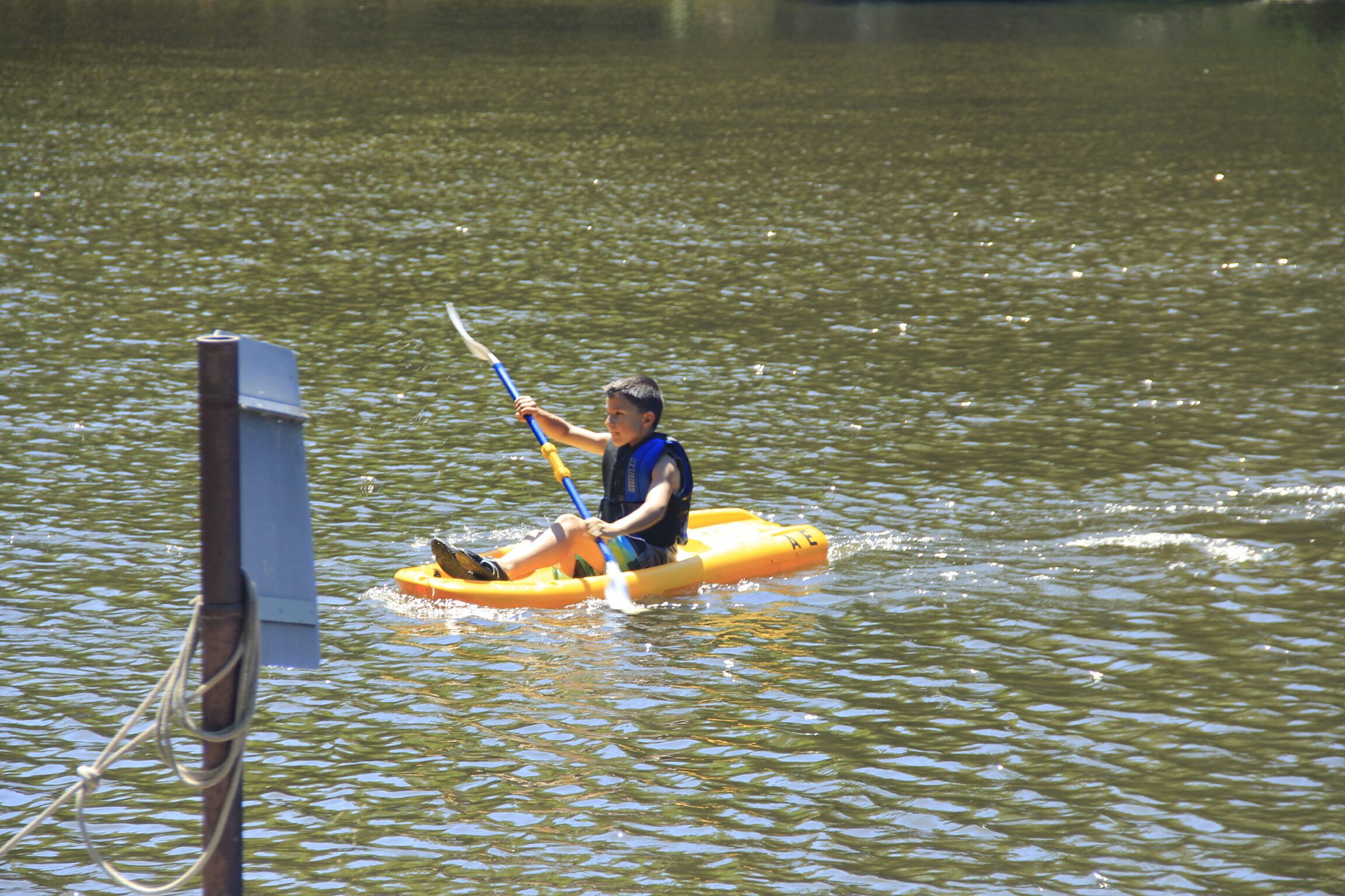 A person in a yellow raft on a body of water.
