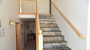 A staircase with stone steps and wooden railings leading to an upper landing. - Beautiful Tahoe Chalet, 5 BR, 3 Bath, Hot Tub, Jacuzzi Bath, 3 Spacious Decks (South Lake Tahoe)