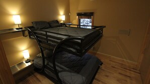 A bunk bed room with two bedside tables, each with a lamp, and an air conditioning unit on the wall. - Quiet Modern Luxury Home w/  Memory Foam Beds, A/C, FAST WiFi and Full Kitchen (Bridgewater)