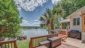 A deck with outdoor furniture overlooking a lake, a covered grill, and a gazebo. - Firefly • Lakefront Estate • Dock + Beach + Kayaks (Belmont)