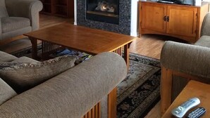 A living room with a fireplace, a television, and a sofa.