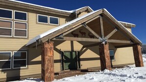 A two-story building with a covered entrance and stone pillars. - LABOR DAY WEEKEND IS NOW AVAILABLE - escape the heat! (Flagstaff)