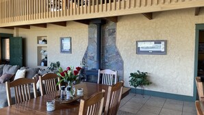 A cozy dining area with a wooden table, chairs, and a fireplace. - LABOR DAY WEEKEND IS NOW AVAILABLE - escape the heat! (Flagstaff)