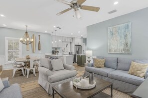 A modern living room with a sofa, armchair, and coffee table.