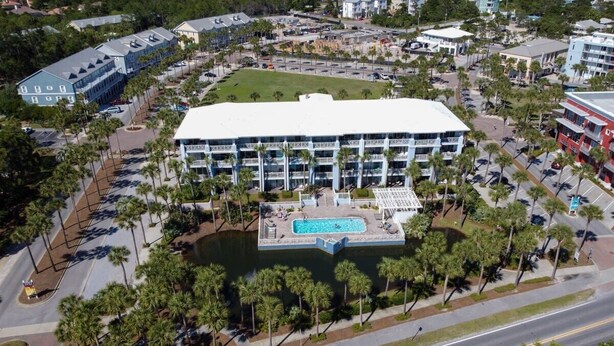 A large building with a swimming pool, surrounded by palm trees and parking lots. - 500 Ft from Beach! 3 Pools (1 Seasonally Heated)! Ground Floor Condo! ~ Cabana 103 at Gulf Place on 30A (Santa Rosa Beach)