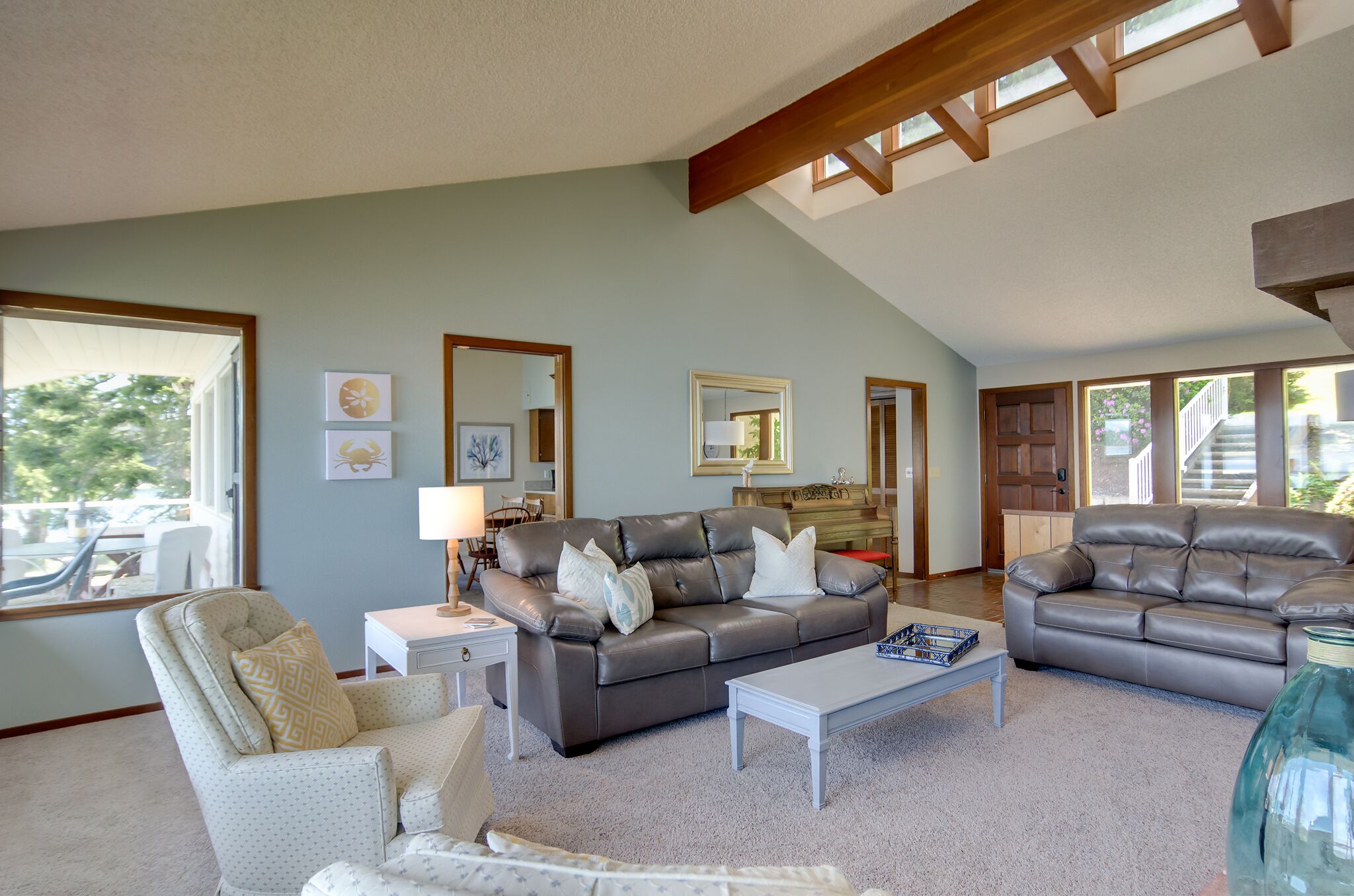 Panoramic views of the Olympic Mtns, waterfront beach and paddleboards