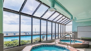 An indoor swimming pool with a view of the ocean, a hot tub, and a sunroof. - Gulf-Front Phoenix X 3BR  Stunning Balcony Views,  (Orange Beach)