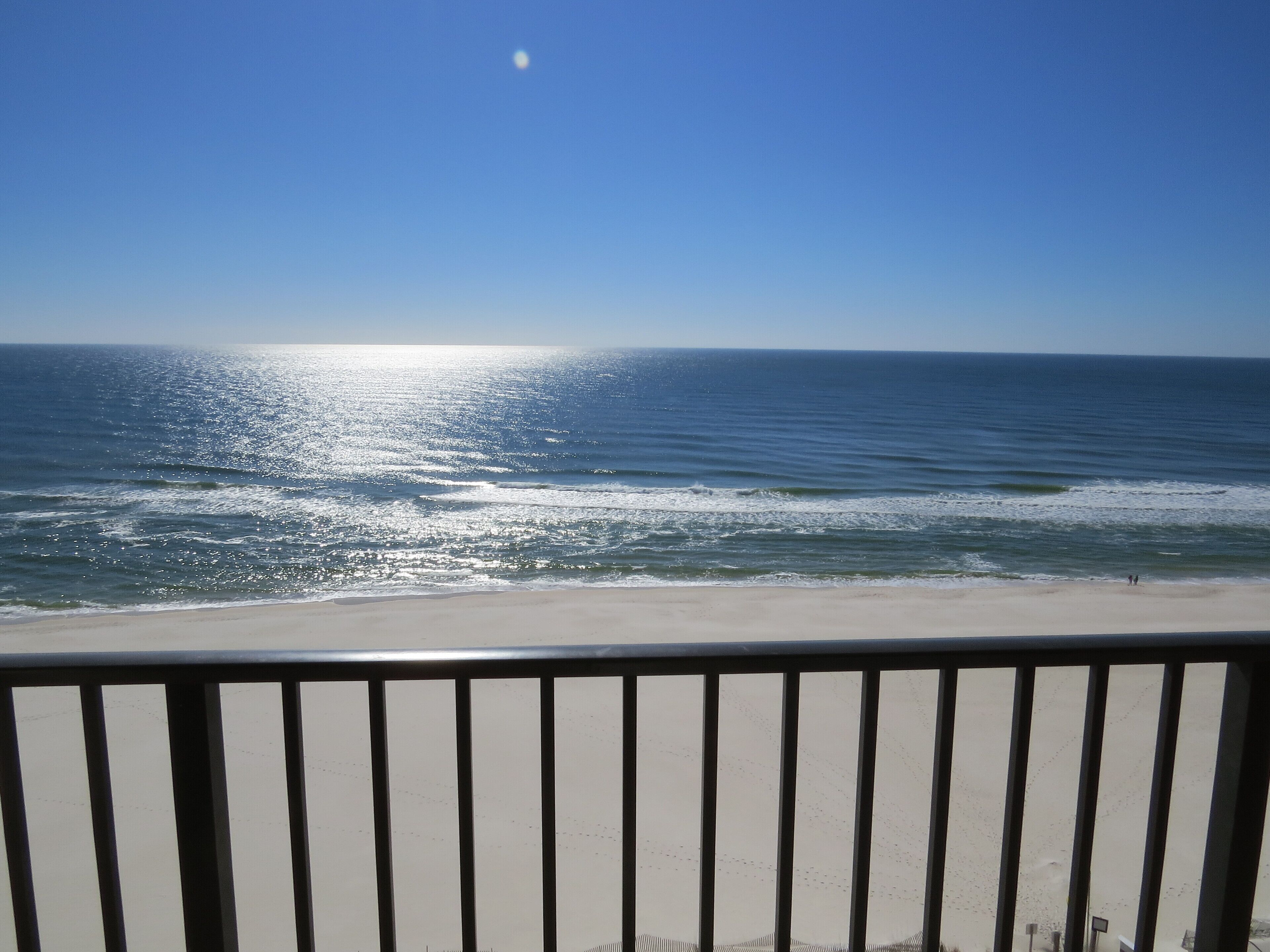 A balcony with a view of the ocean.