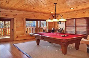 Enjoy a game of pool in this room with a pool table and dining area.