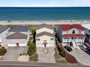 A beachfront residential area with houses, a clear view of the ocean, and a sandy beach. - Namaste at the Beach Oceanfront House, Dog Friendly, Private Beach Access! (Kure Beach)