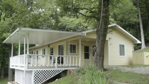 A single-story house with a covered porch and a number '3203' on the front. - Cute and cozy. Located in a very quiet street.   (Camdenton)