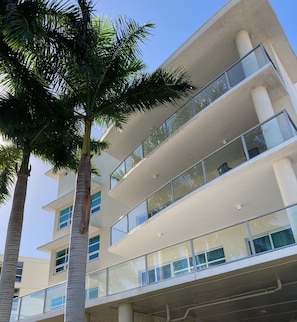 A multi-story building with balconies and large windows. -  Beachfront Property - Luxury Penthouse - Great Location! (Sarasota)