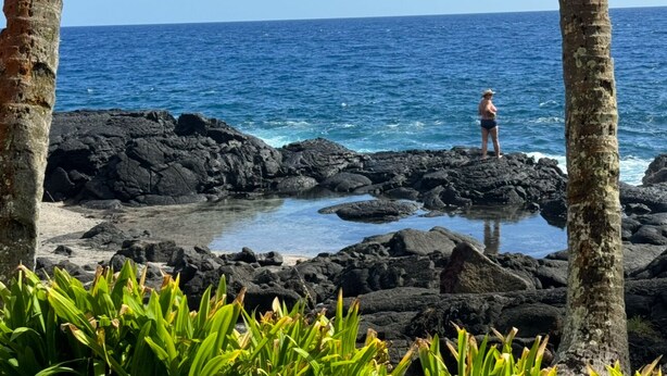 A person standing on a rocky shoreline with ocean in the background. - Nice, Big House near Kehena/ Pohoiki Black Sand Beaches and Lava Fields. (Pahoa/Kalapana-Seaview)