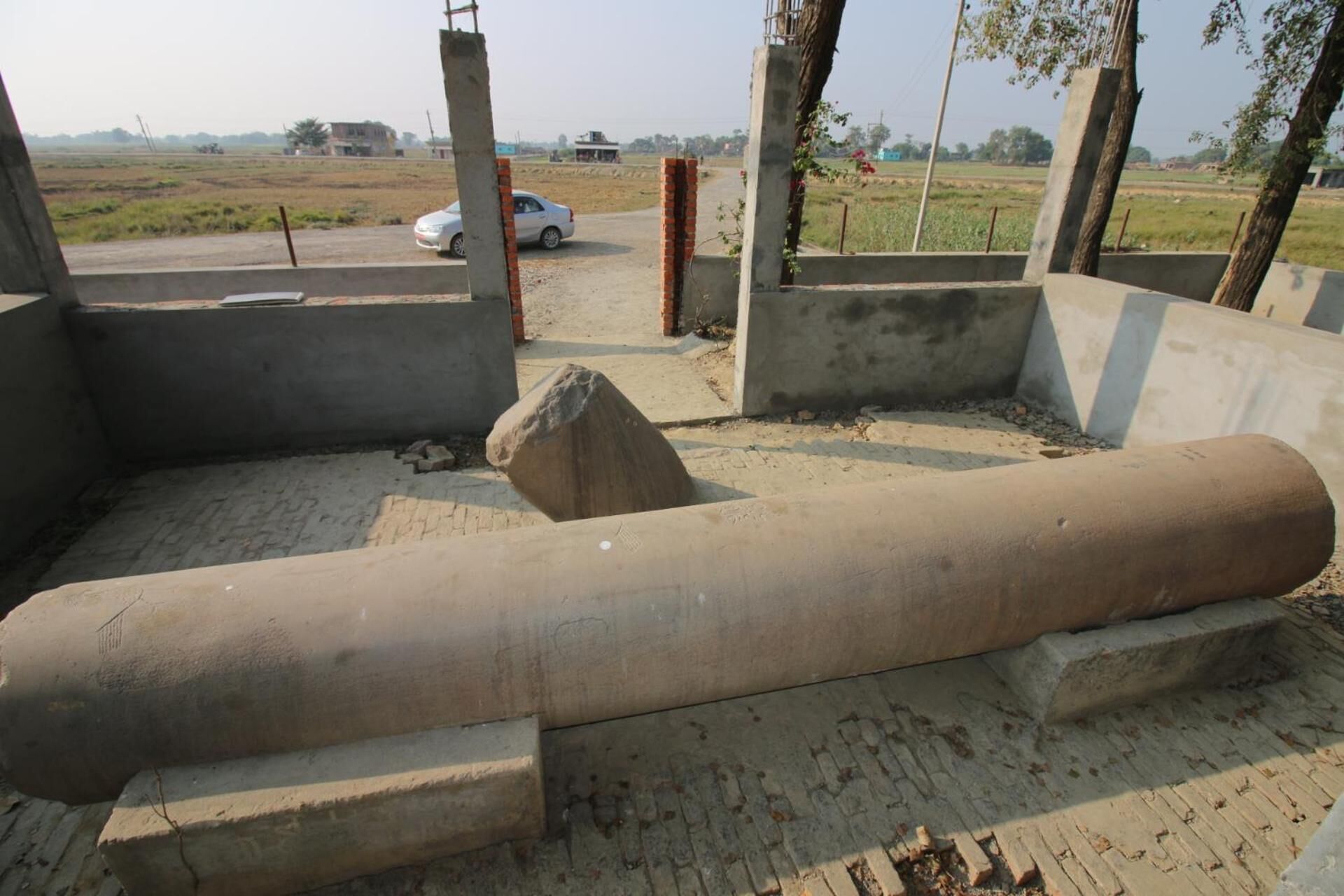 A construction site with concrete structures and a large cylindrical object.