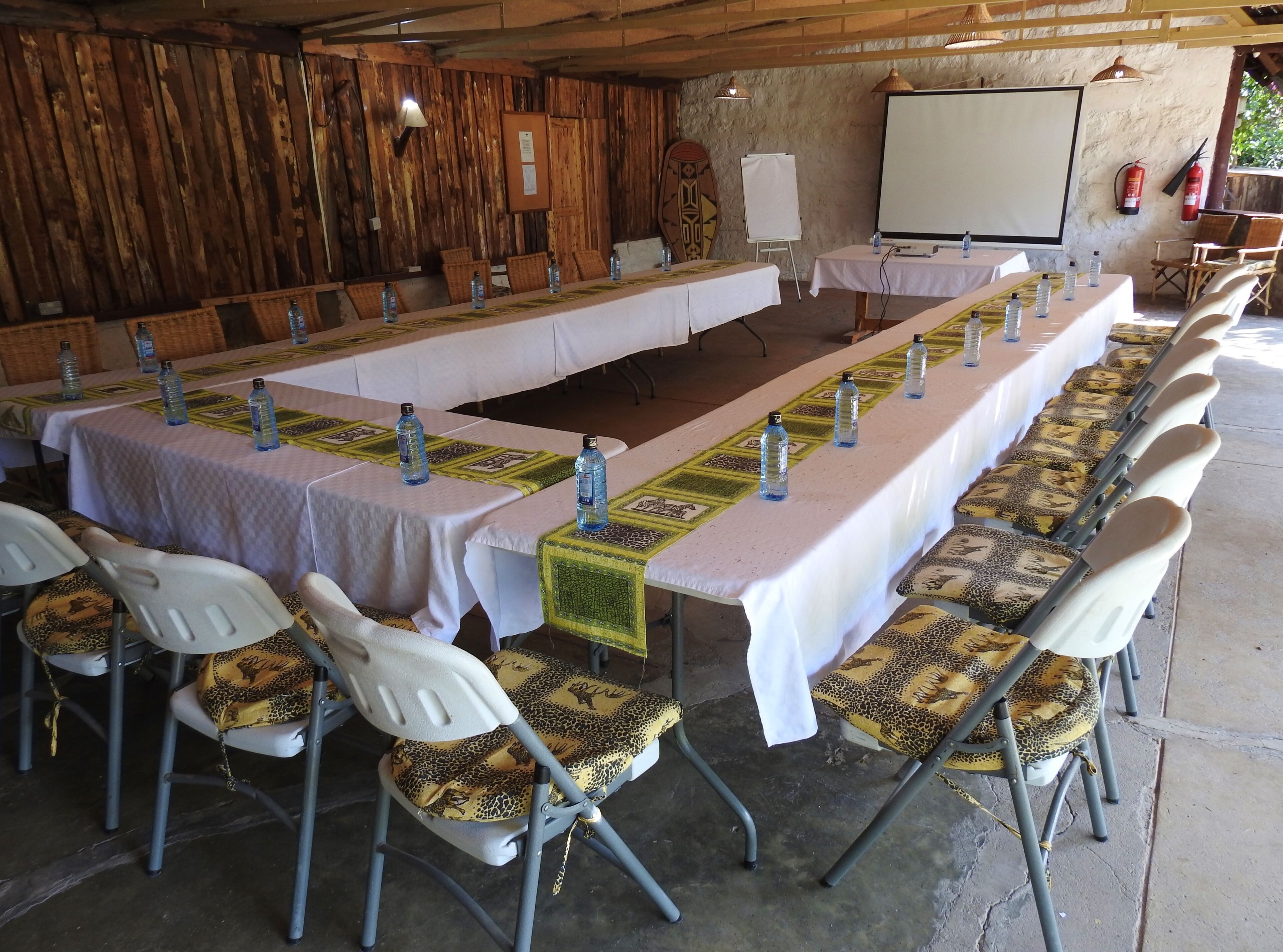 A conference room with a long table, chairs, and a whiteboard.