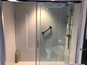 A modern bathroom with a glass shower enclosure, a toilet, and a sink. - The Lowenac Hotel (Camborne)
