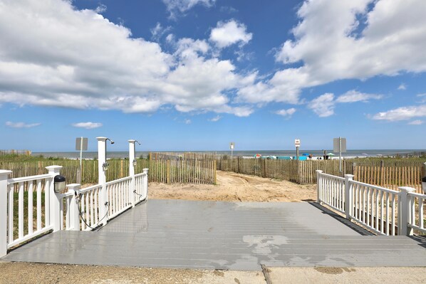 A beach boardwalk with white railings and a sandy path leading to the ocean. - XPLORIE ACTIVITIES & LINENS INCLUDED*!  QUAY 2 BR/2 BA Ocean View Condo with Indoor/Outdoor Pools. (Ocean City)