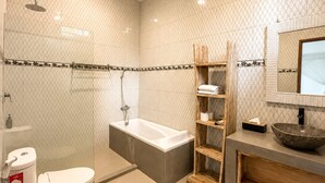 A modern bathroom with a bathtub, toilet, and a large mirror. - Prime location just walking distance to the Boutique shop, Restaurant , Bar (Seminyak)